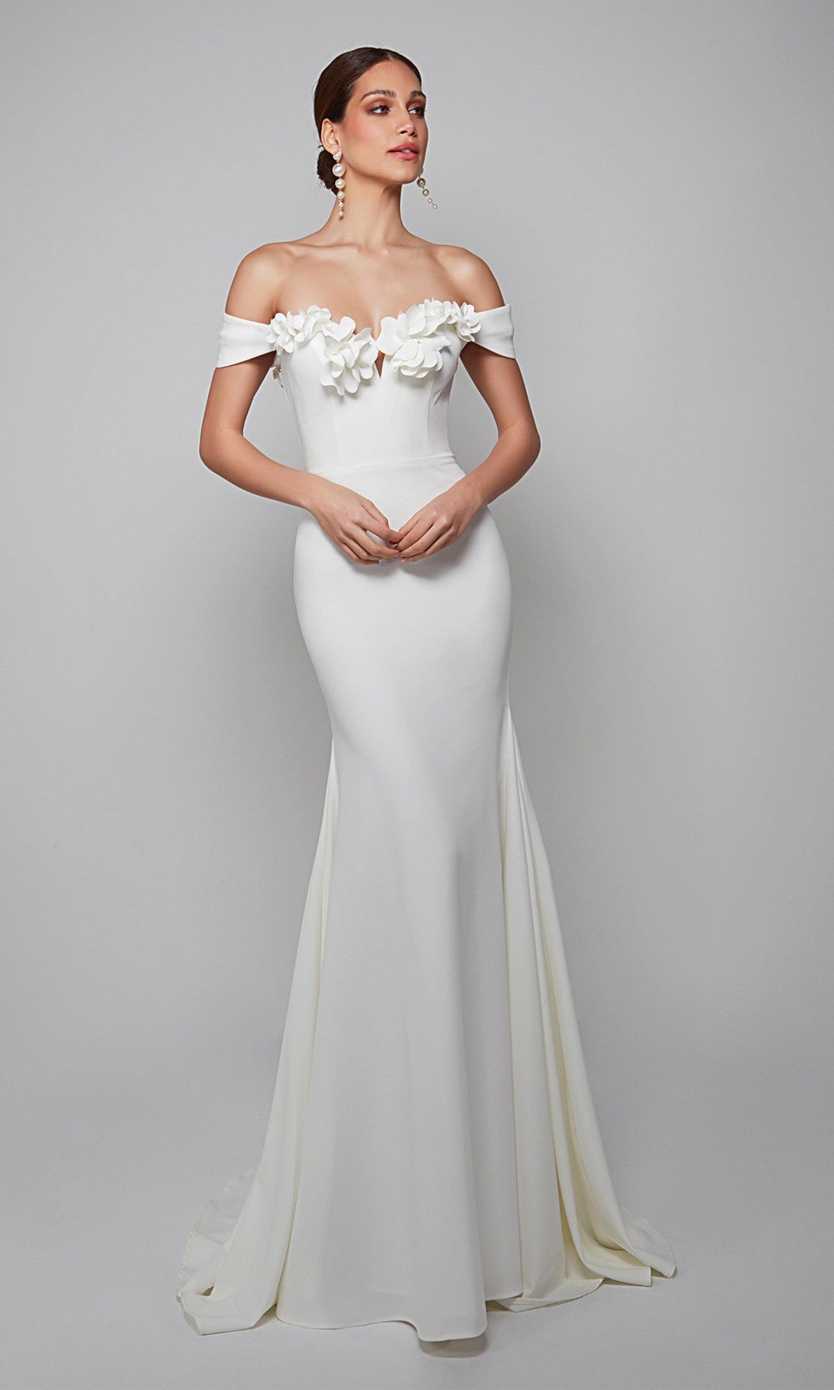 A woman in the Alyce 7062 long formal dress with off-the-shoulder style and 3D floral bodice stands against a plain background—ideal for elegant evening events.